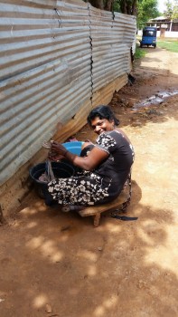 A Tamil woman washing. The Tamils manage to make the best of a harsh situation.